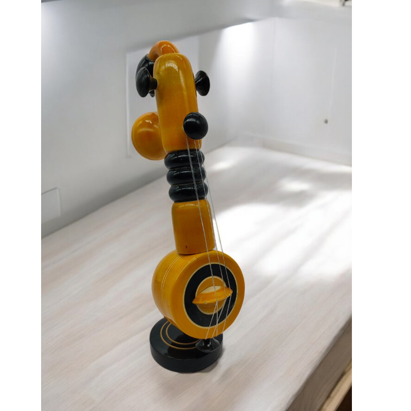 Wooden Veena (1) Handcrafted Wooden Veena – a traditional art piece made by skilled artisans. Perfect for home décor, gifting, and cultural displays, this wooden veena adds an elegant touch of Indian heritage to any space.